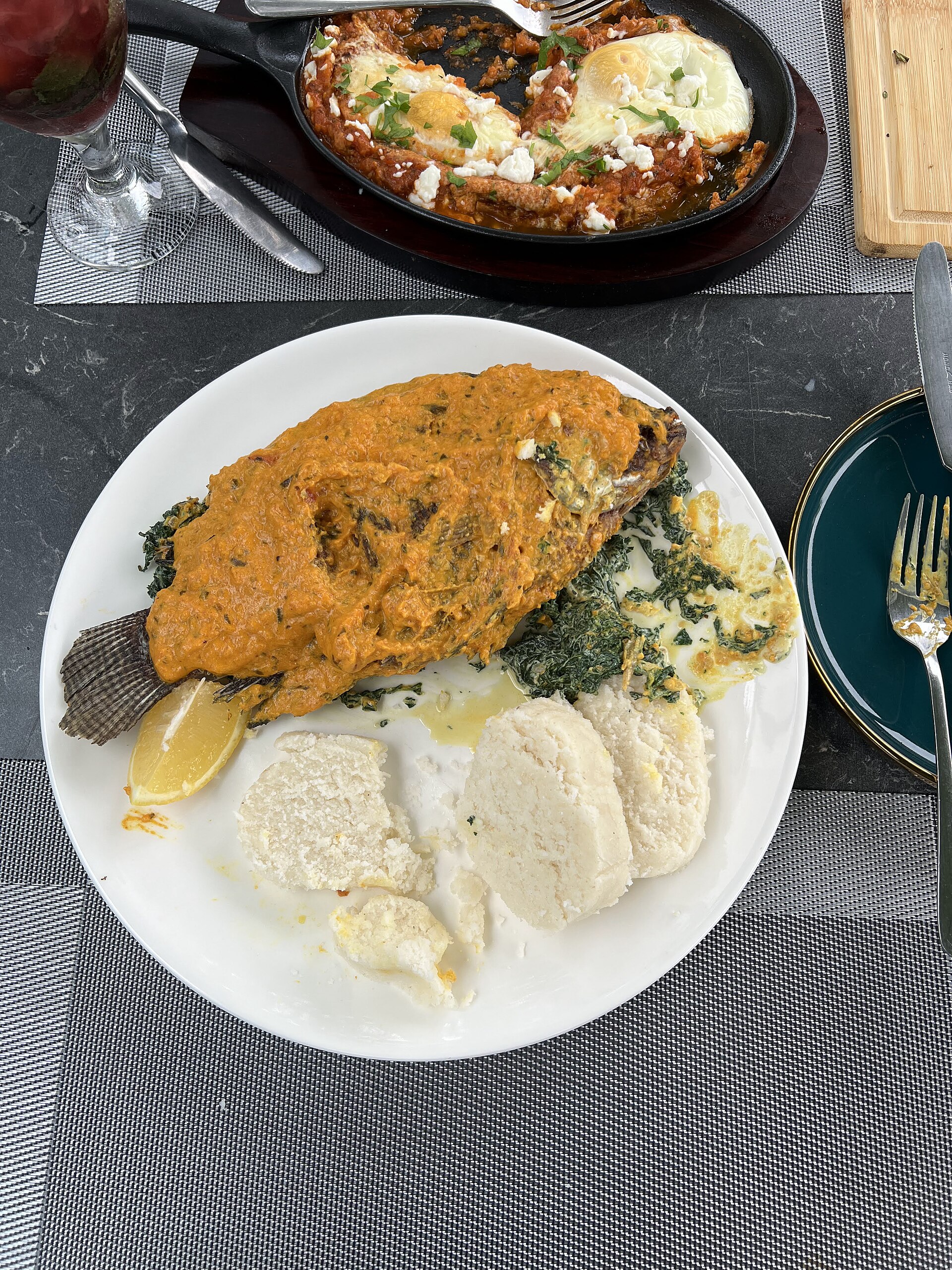 Ugali served with fish and greens